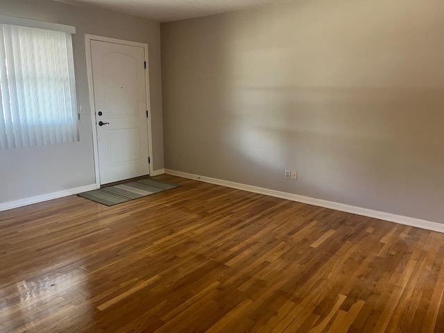 spare room with wood-type flooring