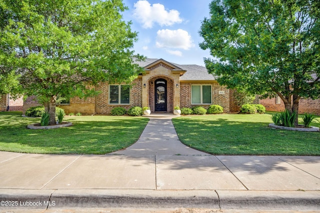 4014 126th St, Lubbock, TX 79423 - view of front facade featuring brick siding and a front lawn