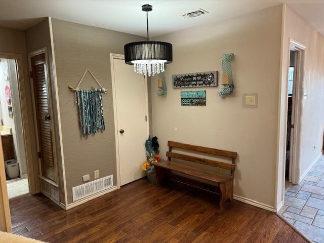 foyer featuring dark hardwood / wood-style flooring and a notable chandelier