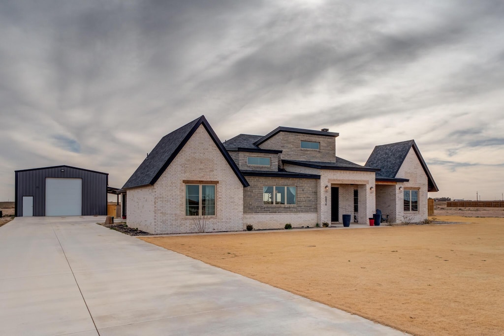 view of front of property with a garage and an outdoor structure