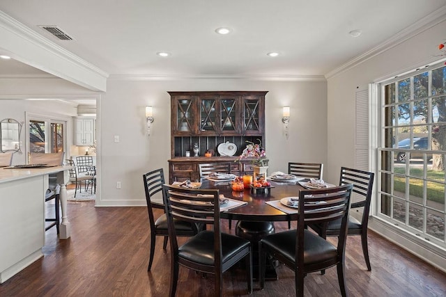 dining space with dark wood-type flooring and crown molding