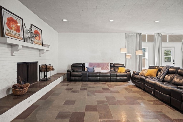 living room with brick wall and a brick fireplace