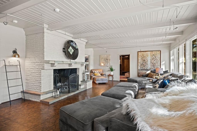 living room with beamed ceiling and a brick fireplace