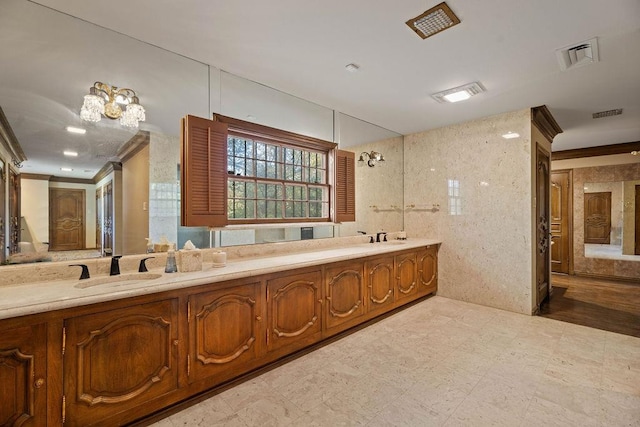 bathroom with tile walls, vanity, and ornamental molding