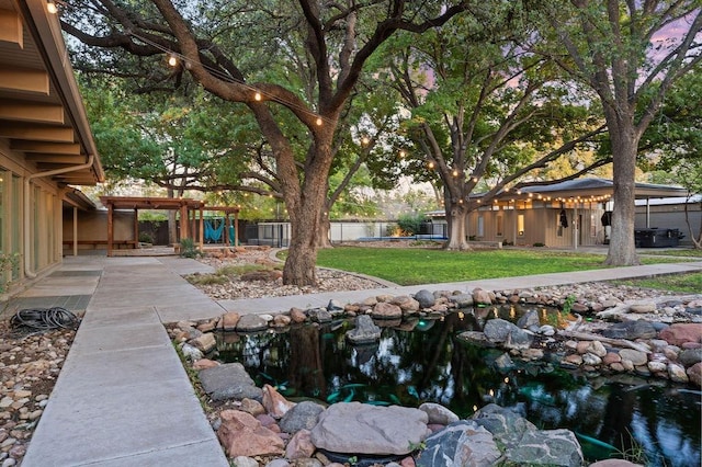 view of yard featuring a garden pond