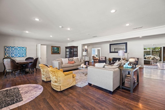 living room featuring dark wood-type flooring and ornamental molding