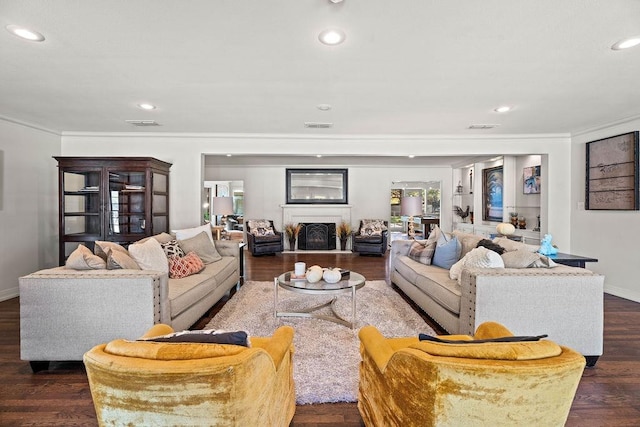 living room with ornamental molding and dark hardwood / wood-style floors