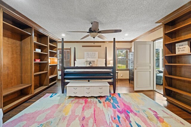 unfurnished bedroom featuring dark hardwood / wood-style flooring, crown molding, and a textured ceiling