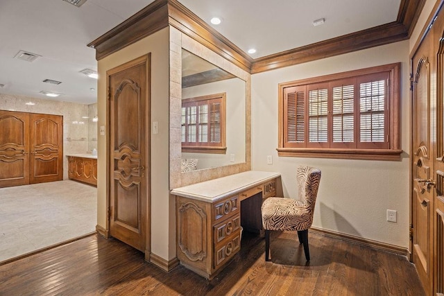 office space featuring ornamental molding, dark hardwood / wood-style floors, and built in desk