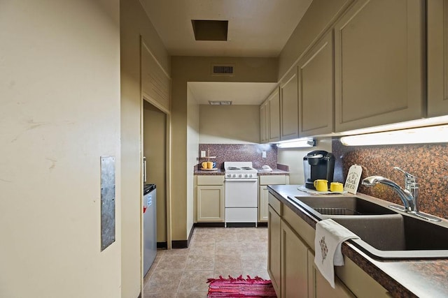 kitchen featuring sink, tasteful backsplash, light tile patterned floors, white range with electric stovetop, and cream cabinetry