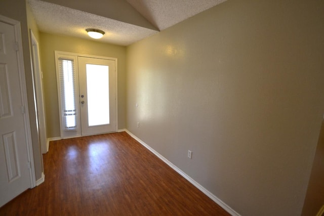 entryway featuring dark hardwood / wood-style flooring and a textured ceiling