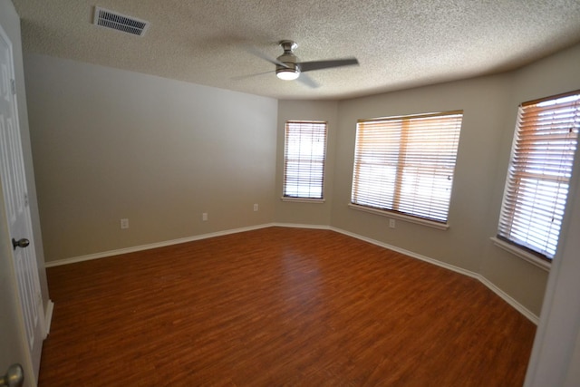 spare room with hardwood / wood-style floors, a textured ceiling, and ceiling fan