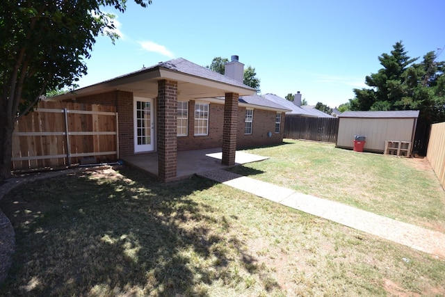 view of yard featuring a storage shed and a patio