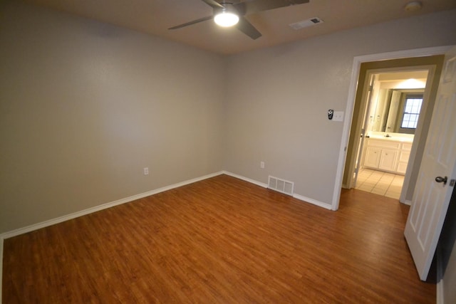 empty room with hardwood / wood-style flooring and ceiling fan