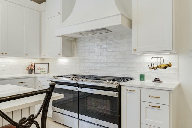 4309 136th St, Lubbock, TX 79423 - kitchen with double oven range, custom exhaust hood, backsplash, and white cabinets