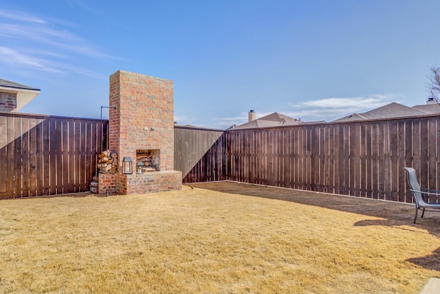 4309 136th St, Lubbock, TX 79423 - view of yard featuring an outdoor brick fireplace