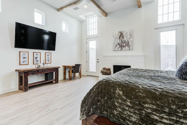 4309 136th St, Lubbock, TX 79423 - bedroom featuring beamed ceiling, a towering ceiling, wood finished floors, multiple windows, and baseboards