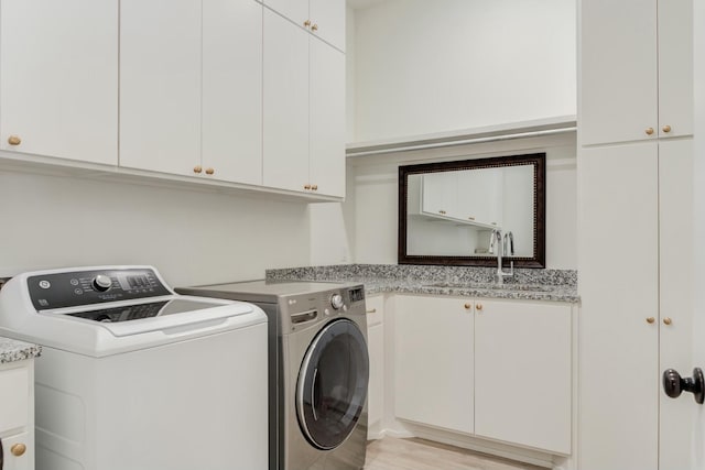4309 136th St, Lubbock, TX 79423 - laundry room featuring cabinet space, independent washer and dryer, and light wood-style flooring