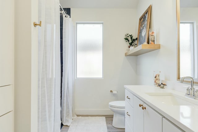 4309 136th St, Lubbock, TX 79423 - bathroom featuring toilet, vanity, wood finished floors, baseboards, and a shower with shower curtain