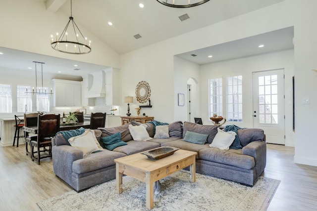 4309 136th St, Lubbock, TX 79423 - living room featuring a chandelier, light wood-style floors, plenty of natural light, recessed lighting, and beam ceiling