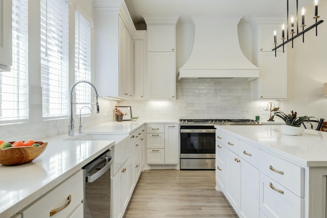 4309 136th St, Lubbock, TX 79423 - kitchen featuring custom range hood, stainless steel appliances, a sink, white cabinets, and backsplash