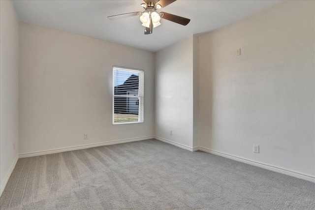 unfurnished room with light colored carpet and ceiling fan