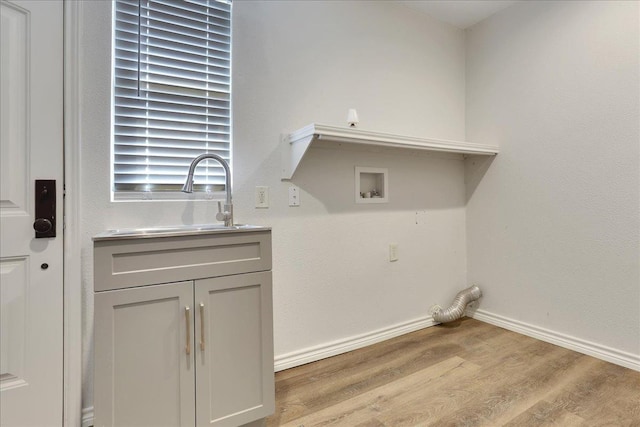 washroom featuring washer hookup, light hardwood / wood-style floors, and sink