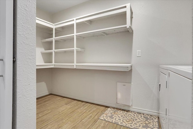 interior space with independent washer and dryer and light wood-type flooring