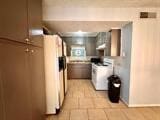 kitchen featuring fridge with ice dispenser