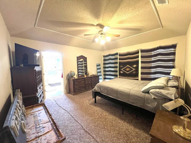 carpeted bedroom with ceiling fan and a textured ceiling