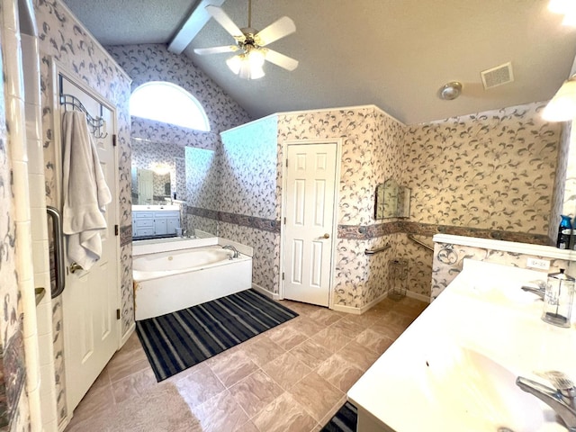 bathroom with a tub, vaulted ceiling with beams, vanity, ceiling fan, and a textured ceiling