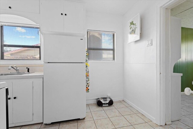 bathroom with tile patterned flooring, vanity, and a wealth of natural light