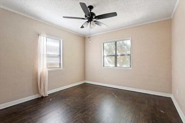 spare room with dark hardwood / wood-style flooring, a wealth of natural light, ornamental molding, and a textured ceiling