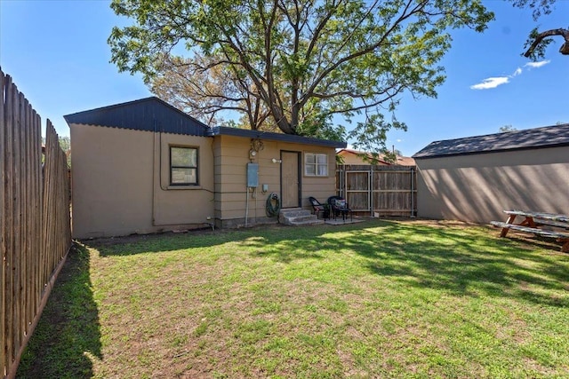 rear view of property featuring a yard