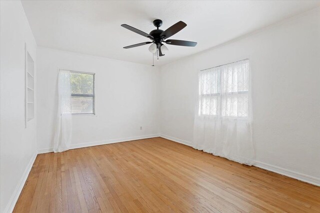 unfurnished room featuring light hardwood / wood-style flooring and ceiling fan