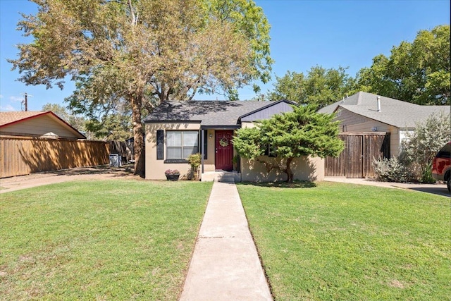 bungalow-style home with a front yard