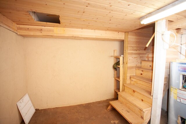 basement featuring wood ceiling and water heater