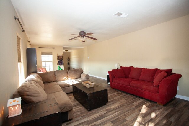 living room featuring dark hardwood / wood-style flooring and ceiling fan