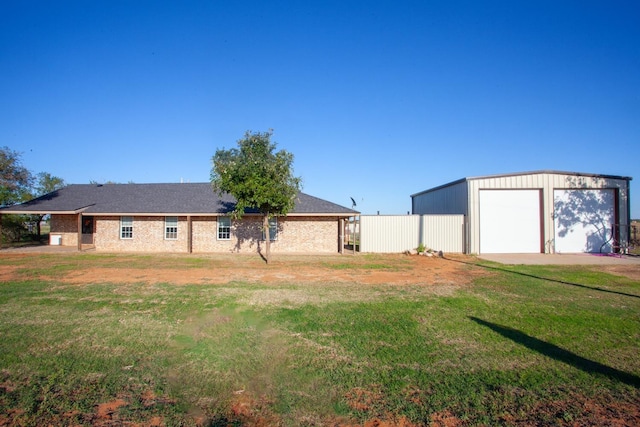 view of yard featuring a garage and an outdoor structure