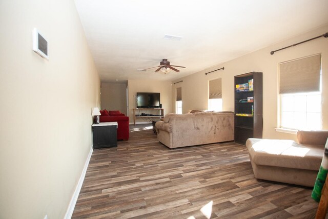 living room featuring dark hardwood / wood-style floors and ceiling fan