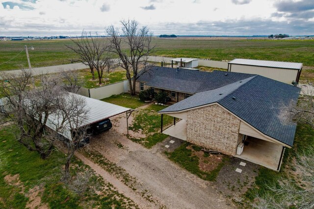 birds eye view of property with a rural view