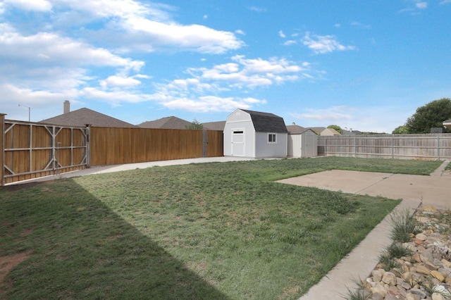 view of yard featuring a fenced backyard, an outdoor structure, a patio, and a shed