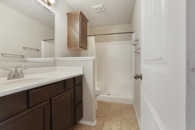 bathroom with tile patterned flooring, vanity, toilet, and a shower with curtain