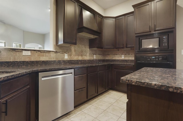 kitchen with dark brown cabinetry, black appliances, custom range hood, and backsplash