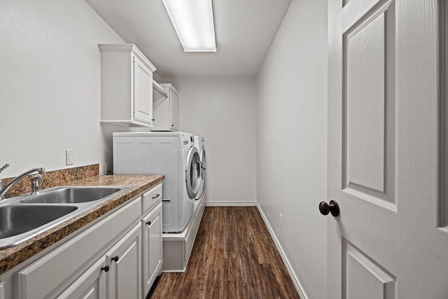 washroom featuring cabinets, dark hardwood / wood-style floors, sink, and washer and dryer