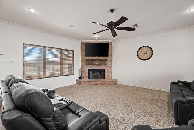 living room with ornamental molding, carpet flooring, ceiling fan, and a fireplace