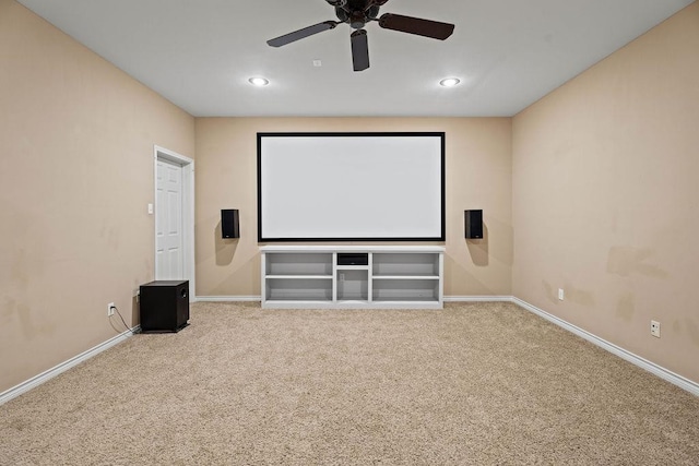 carpeted cinema room with ceiling fan