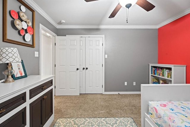 bedroom with crown molding, light colored carpet, ceiling fan, and a closet