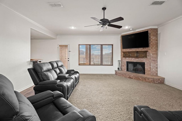 carpeted living room featuring ornamental molding, ceiling fan, and a fireplace