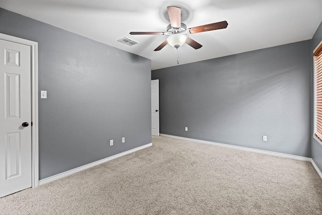 carpeted spare room with ceiling fan